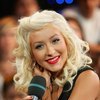 Christina Aguilera exposed her leopard bra down her blouse