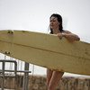 Evangeline Lilly exposed her bikini body behind a surfboard