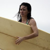 Evangeline Lilly exposed her bikini body behind a surfboard