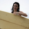 Evangeline Lilly exposed her bikini body behind a surfboard