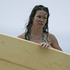 Evangeline Lilly exposed her bikini body behind a surfboard