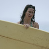 Evangeline Lilly exposed her bikini body behind a surfboard